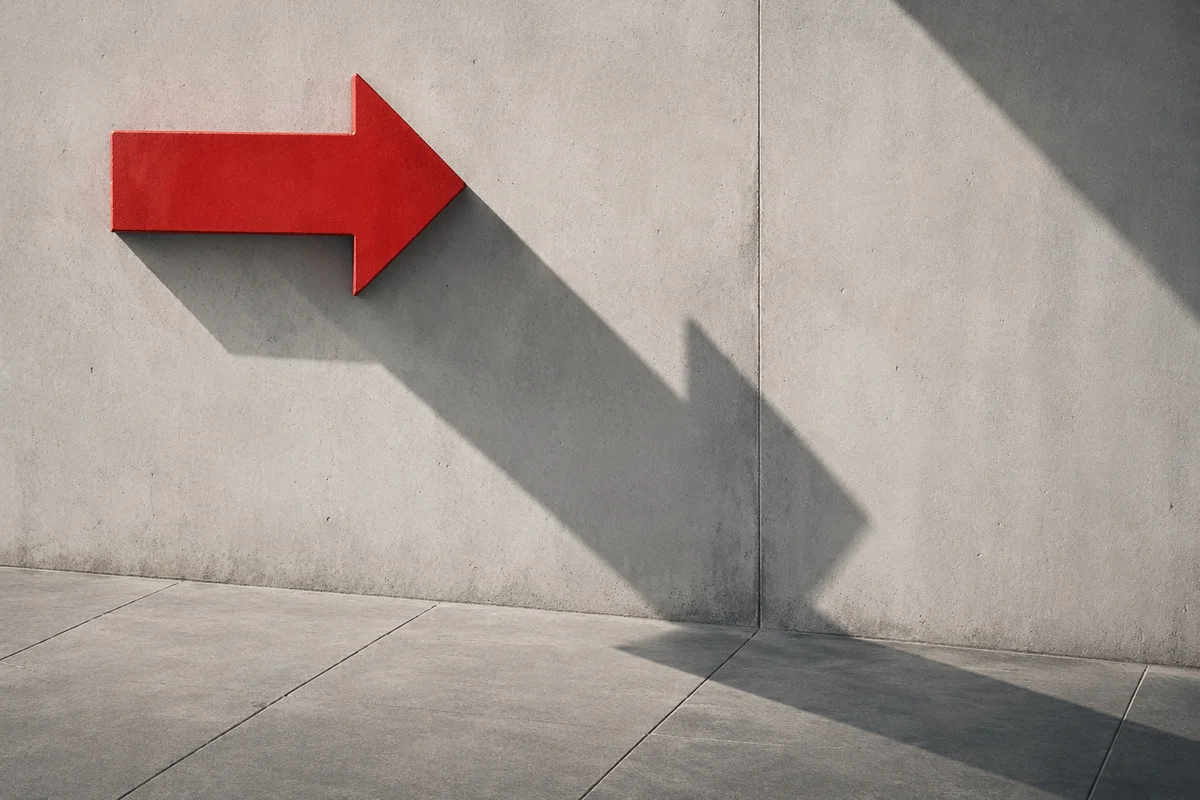 Red Arrow Sign on Concrete Wall