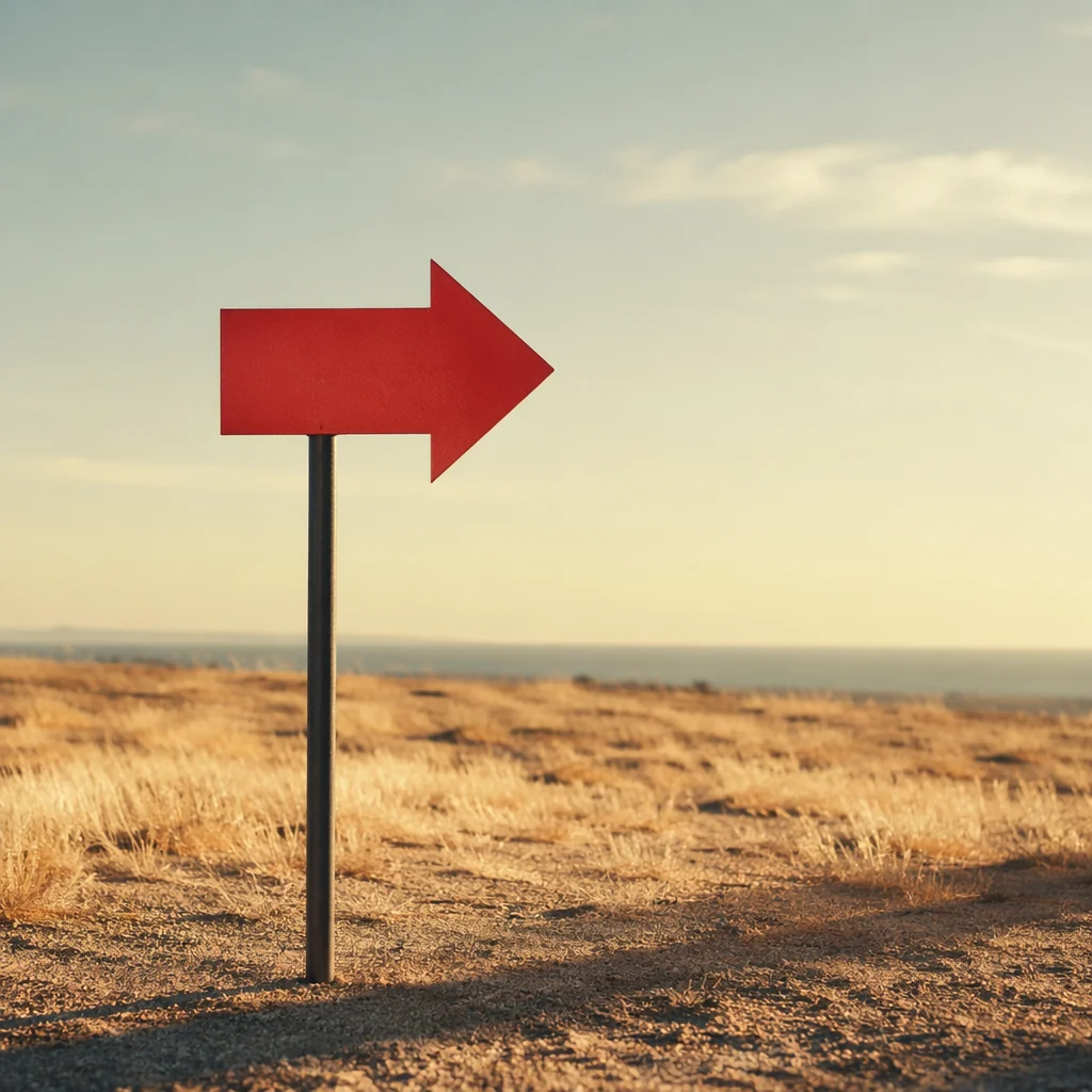 Red Arrow Sign in Minimal Desert Landscape