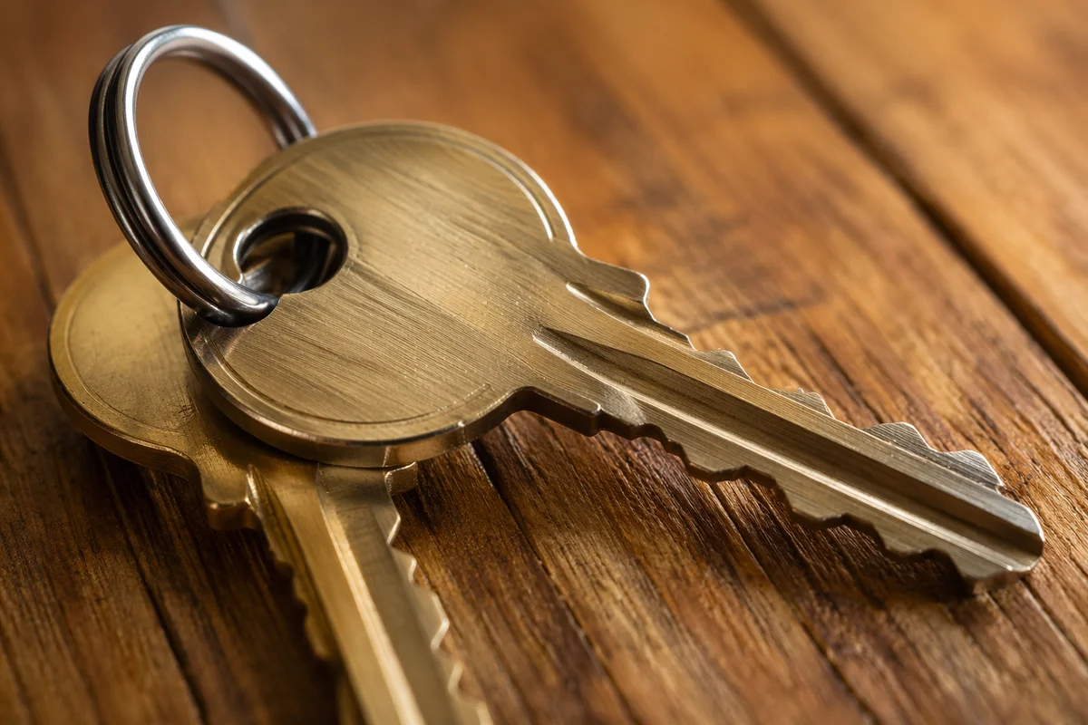 Overlapping Metal Keys on Wooden Table