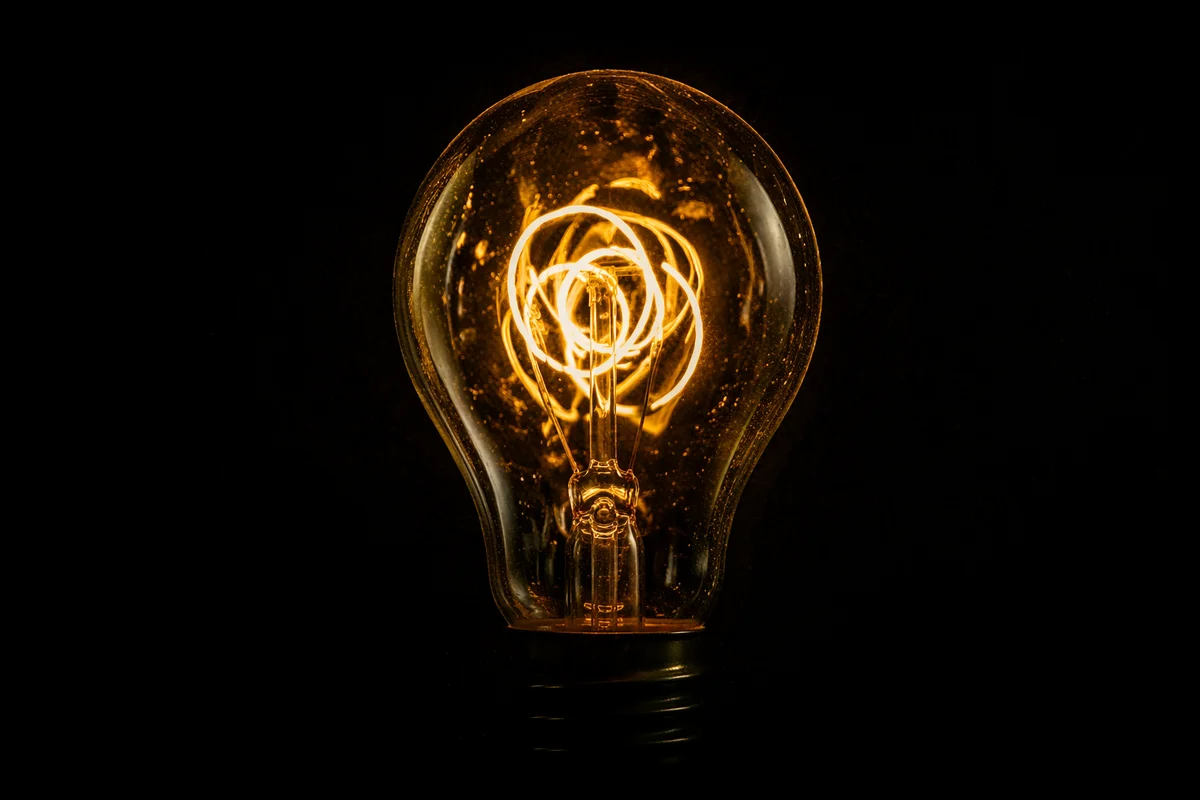 Glowing Light Bulb Idea in Darkness