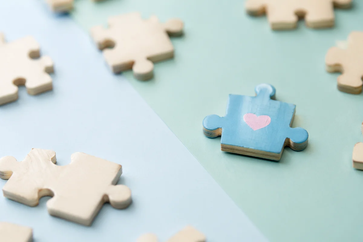 Wooden Puzzle Pieces Symbolizing Teamwork Connection