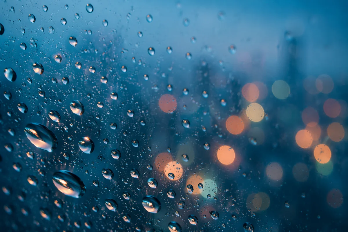 Rain Droplets on Glass at Dusk