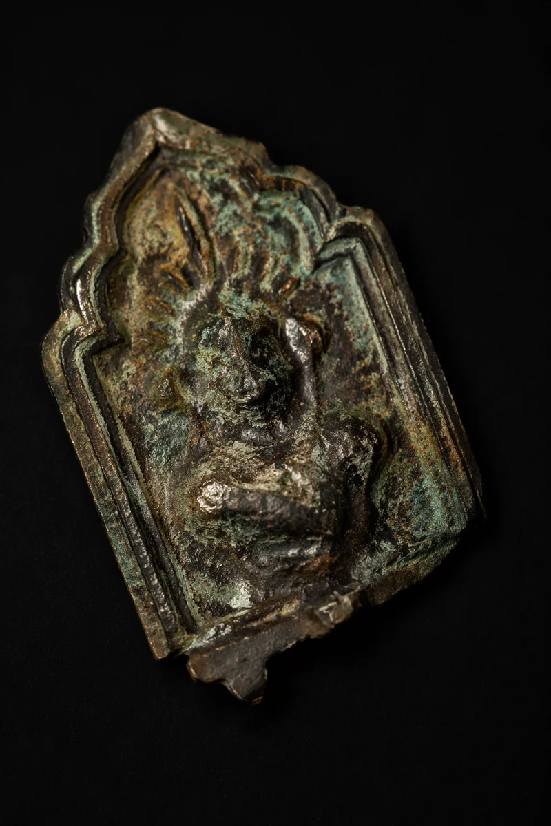 Weathered Bronze Plaque Fragment on Black