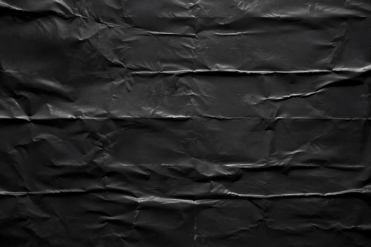 Matte Black Crumpled Paper Texture Background