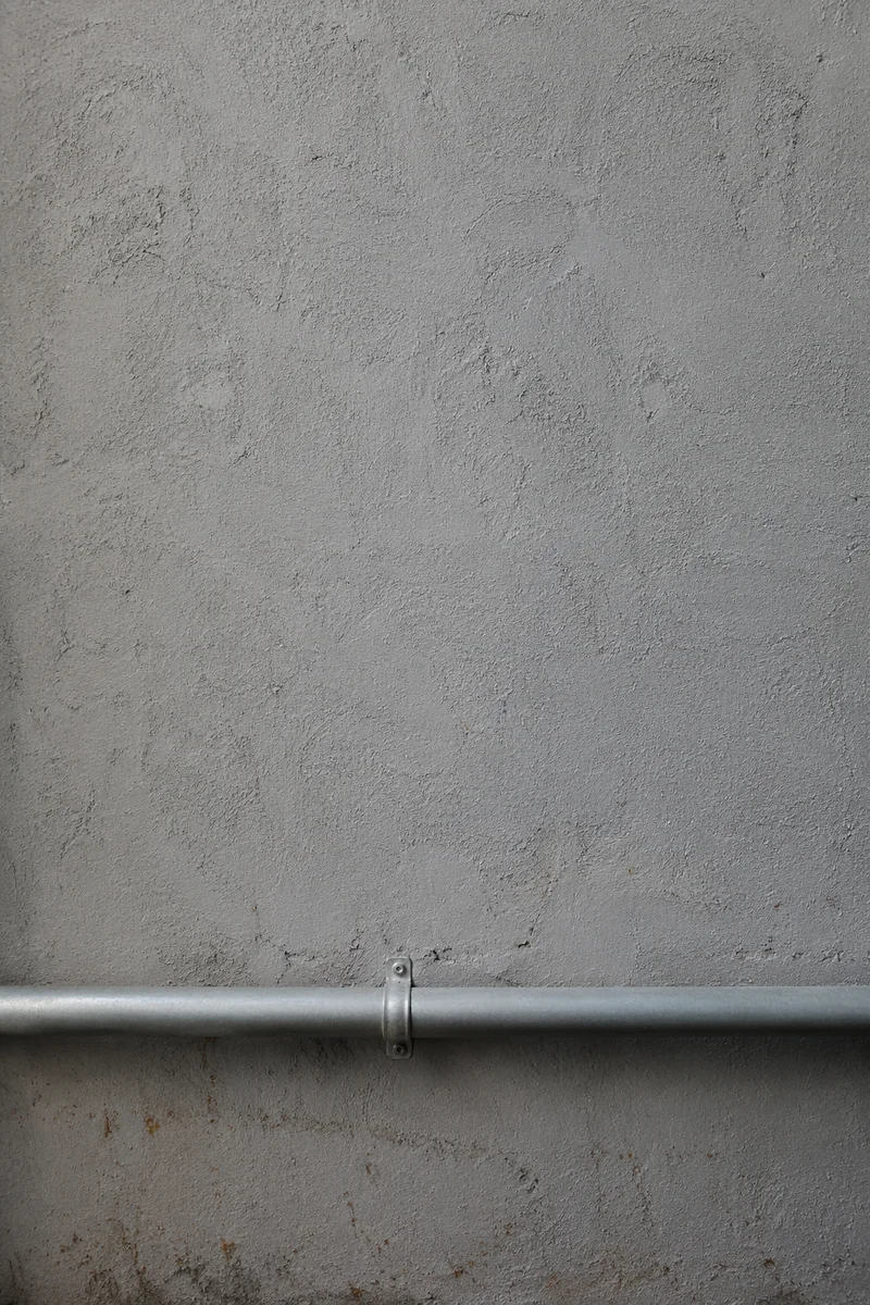 Grey Concrete Wall With Industrial Pipe