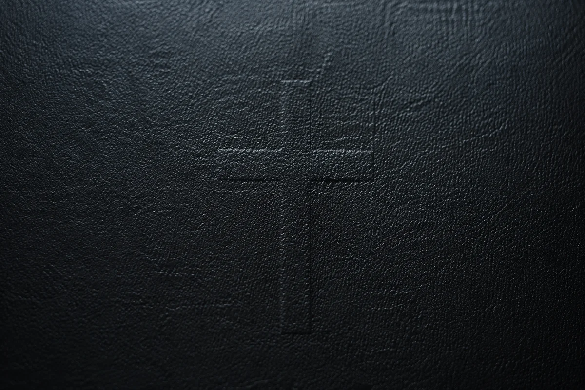 Dark Textured Background with Subtle Cross