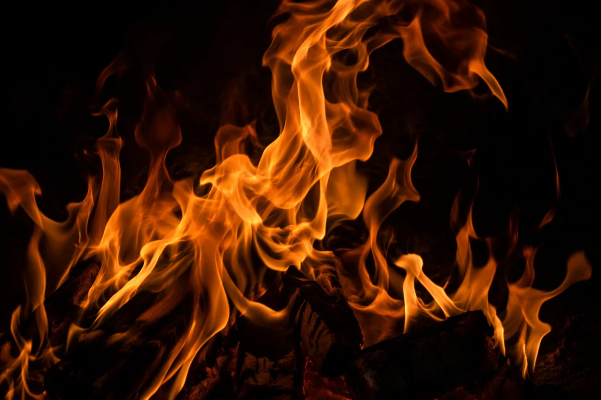 Dark Dramatic Flames Over Charred Wood