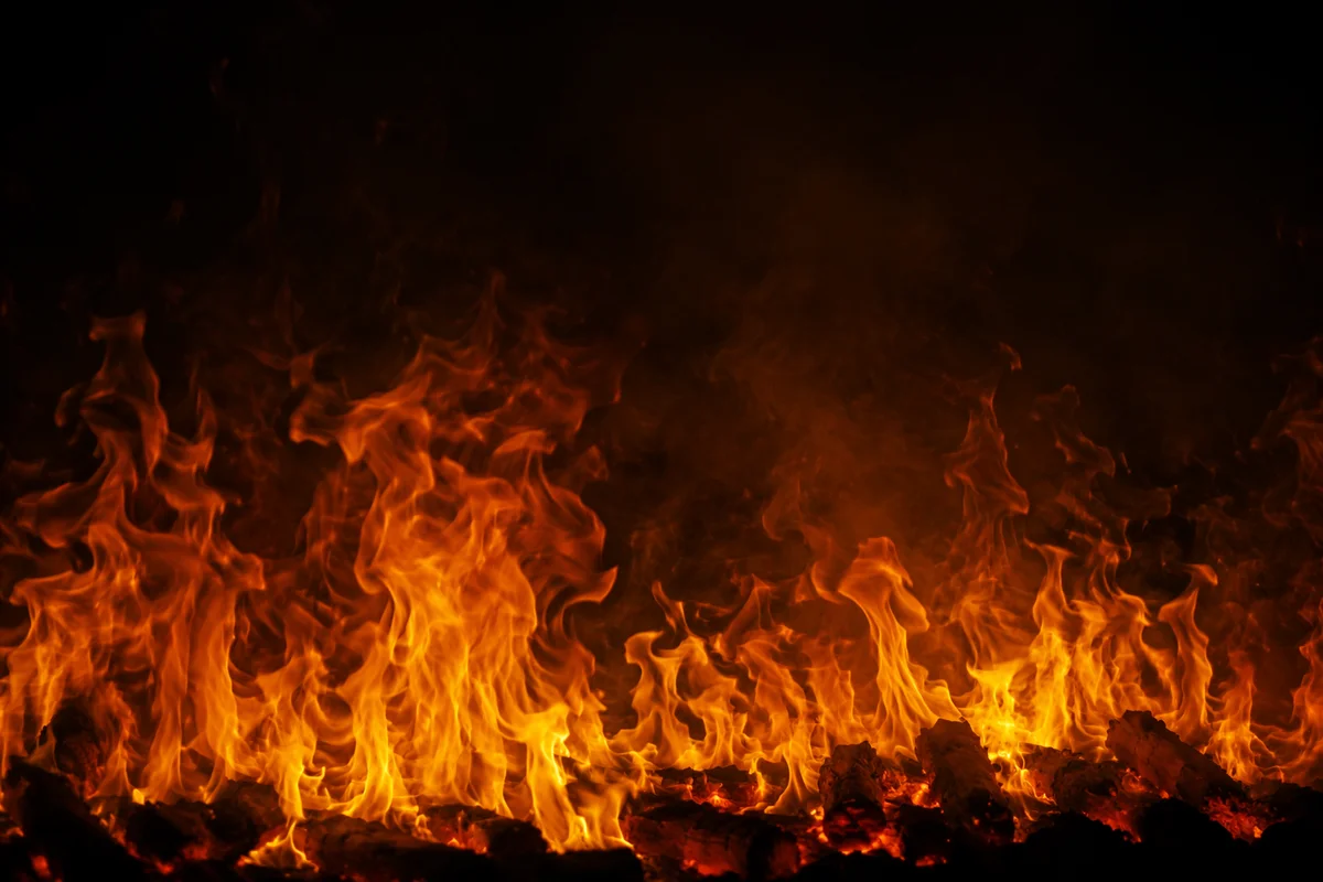 Dramatic Flames Rising in Dark Smoke
