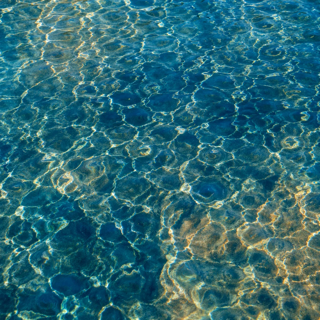 Golden Reflections on Flowing Turquoise Water