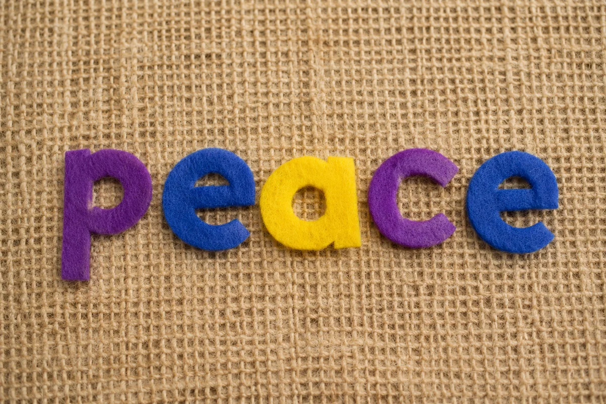 Peace Felt Letters on Burlap Background
