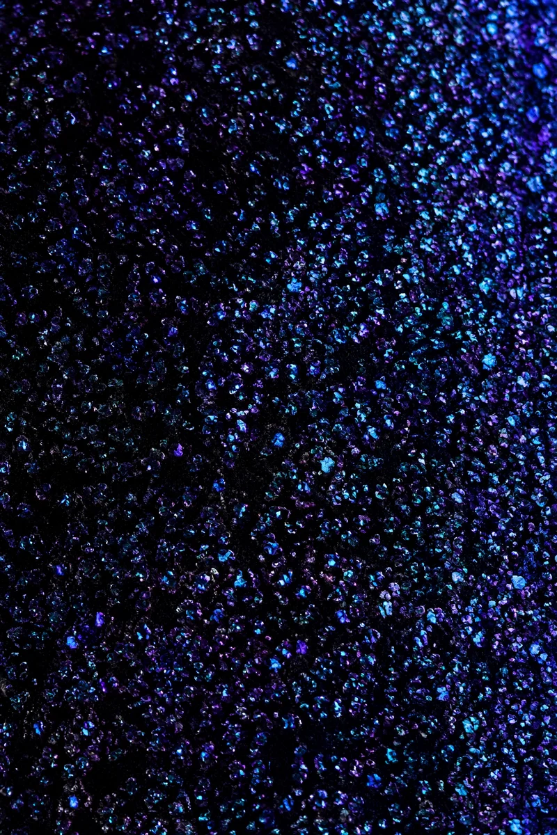 Festive Violet Glitter on Black Background