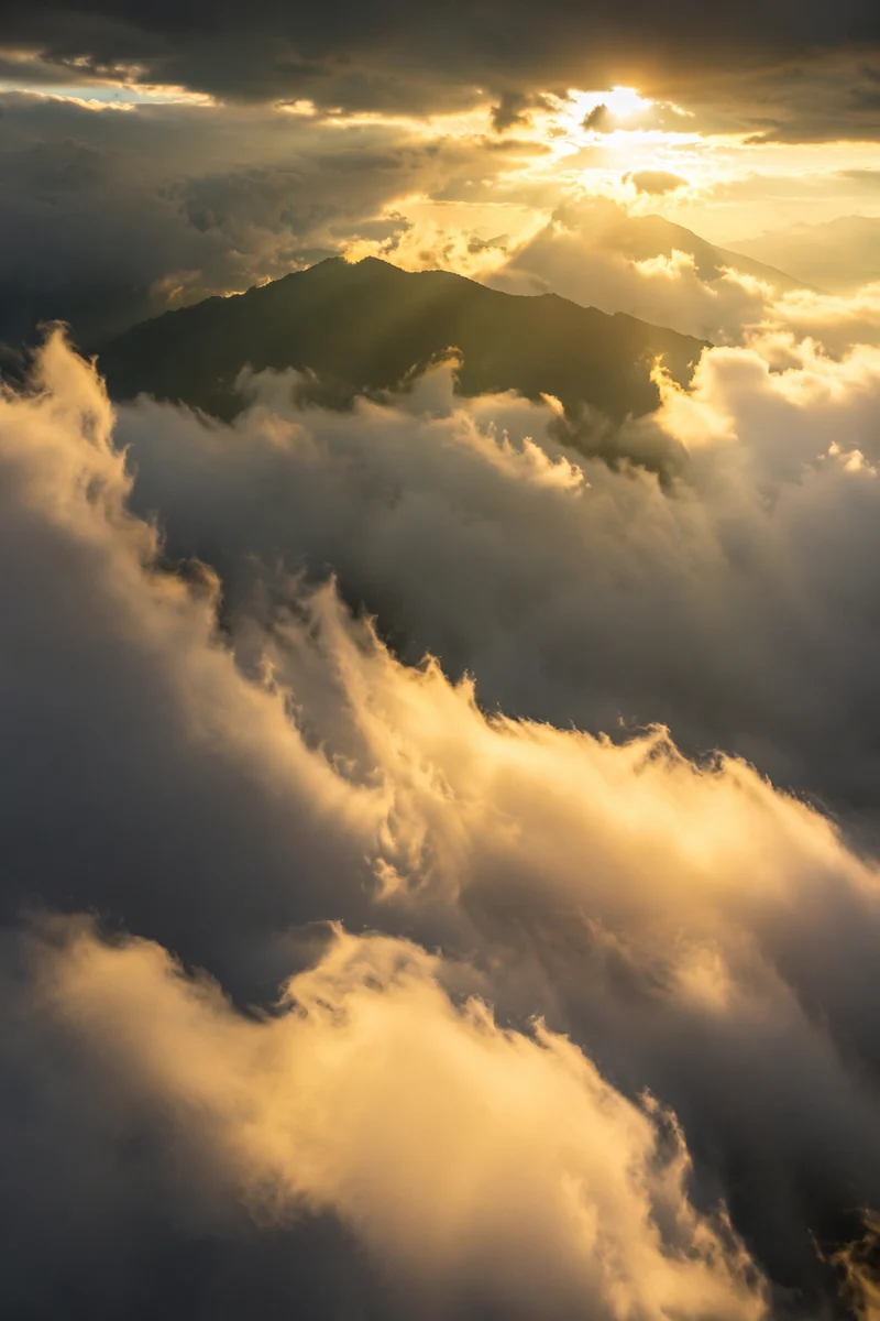 Golden Heavenly Light Through Mountain Clouds