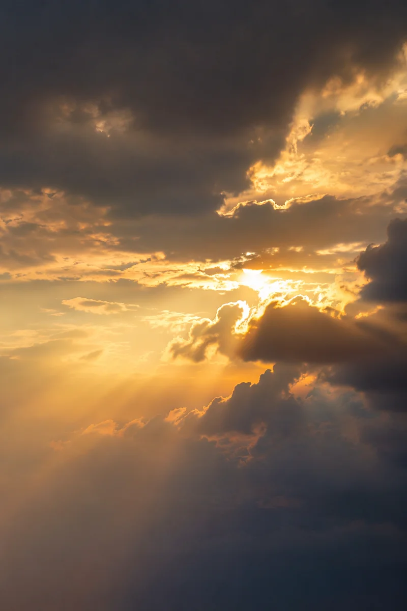 Golden Heavenly Light Rays Through Clouds