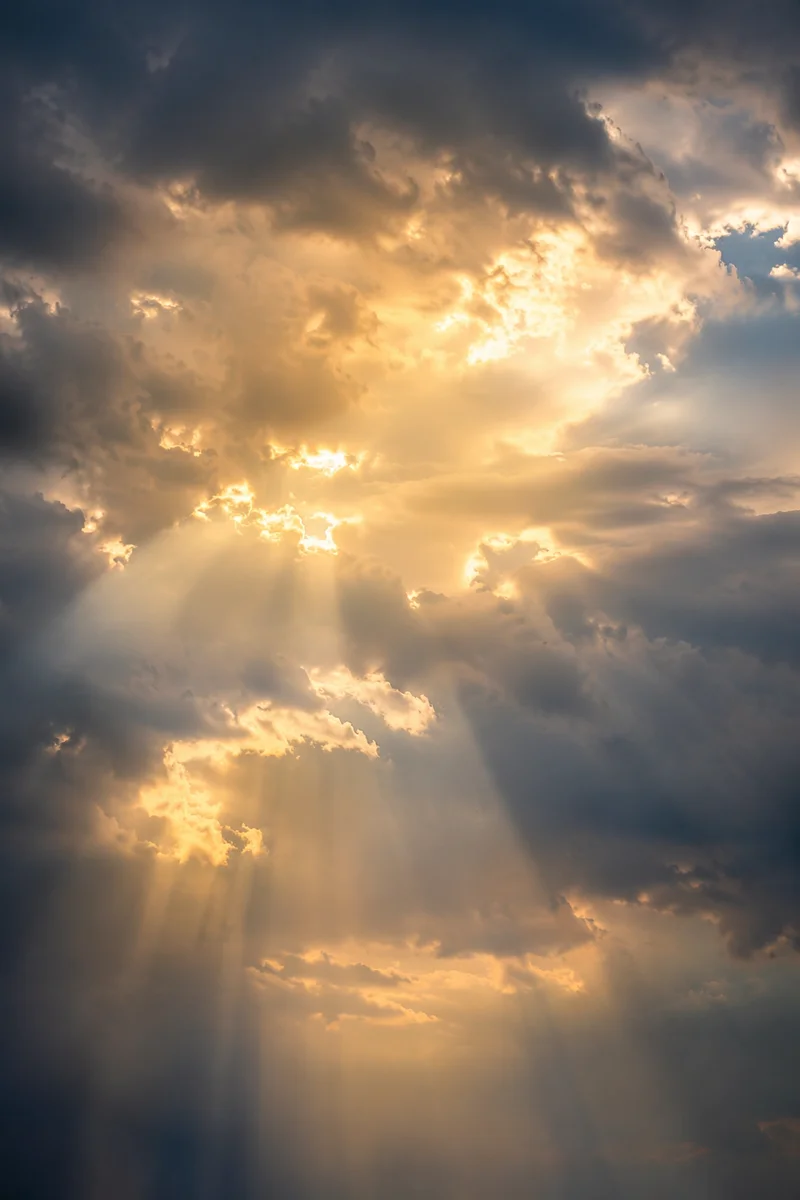 Golden Light Rays Through Heavenly Clouds