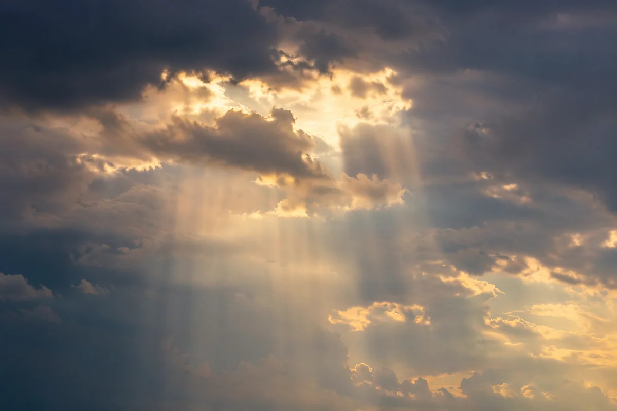 Golden Heavenly Light Rays Through Clouds