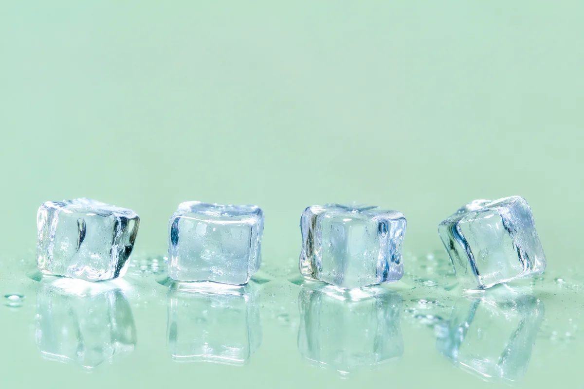 Melting Ice Cubes on Fresh Green Background