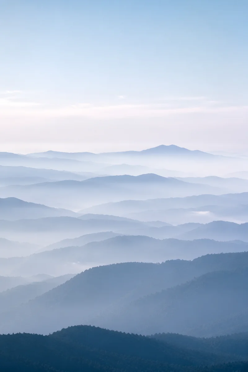 Soft Blue Misty Mountain Background