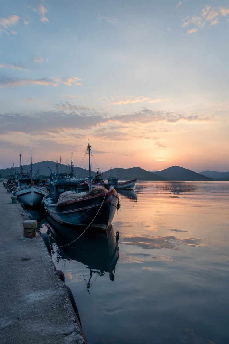 Calming Dawn Waterfront with Moored Fishing Boats