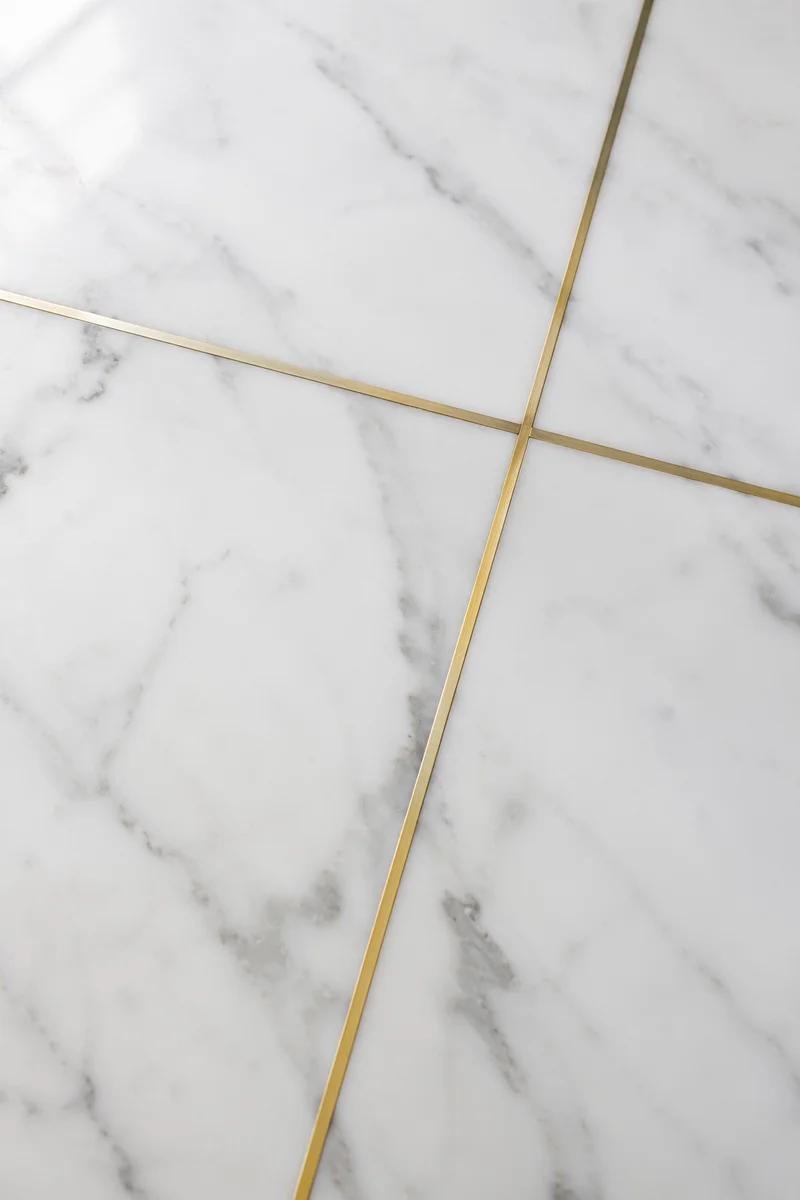 White Marble Background with Gold Cross Accent