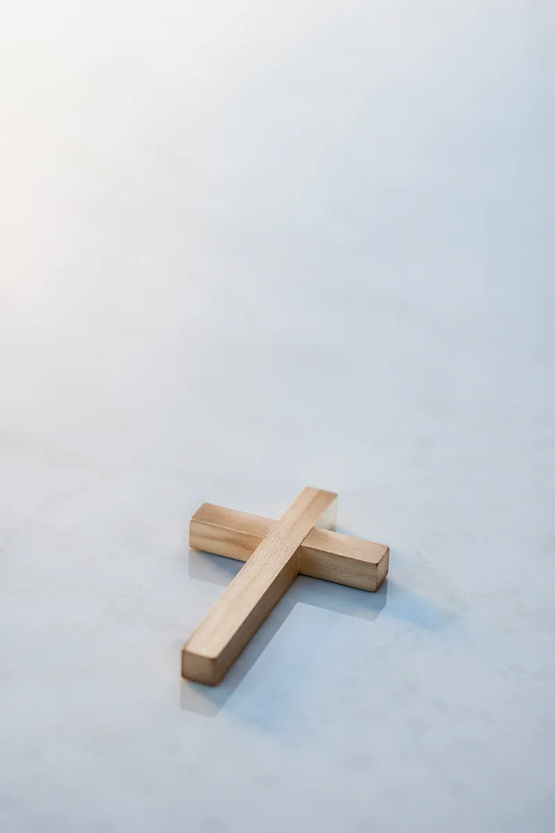 Minimal Wooden Cross on Serene Blue Background