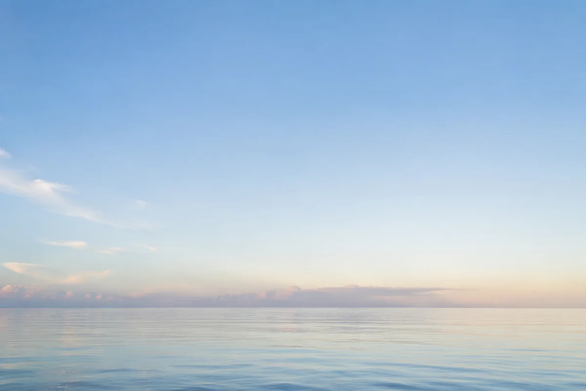 Calm Ocean Horizon Under Blue Sky