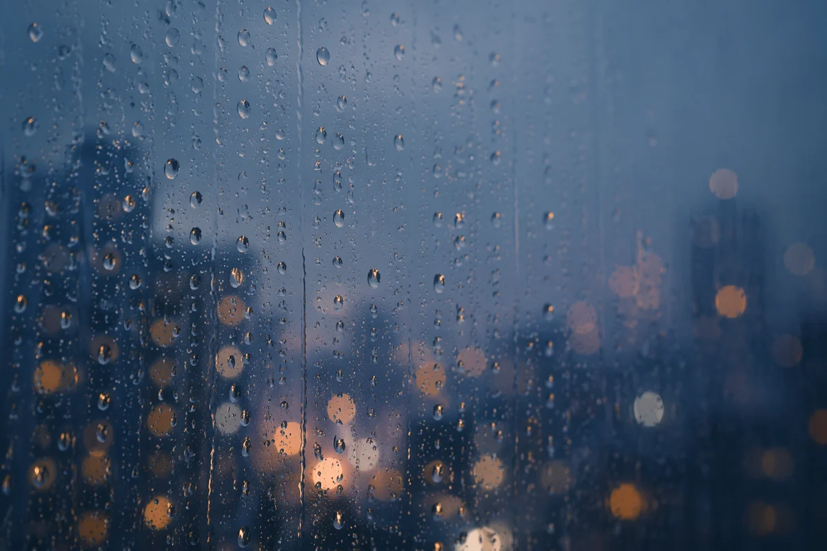 Rain Drops on Window with City Bokeh
