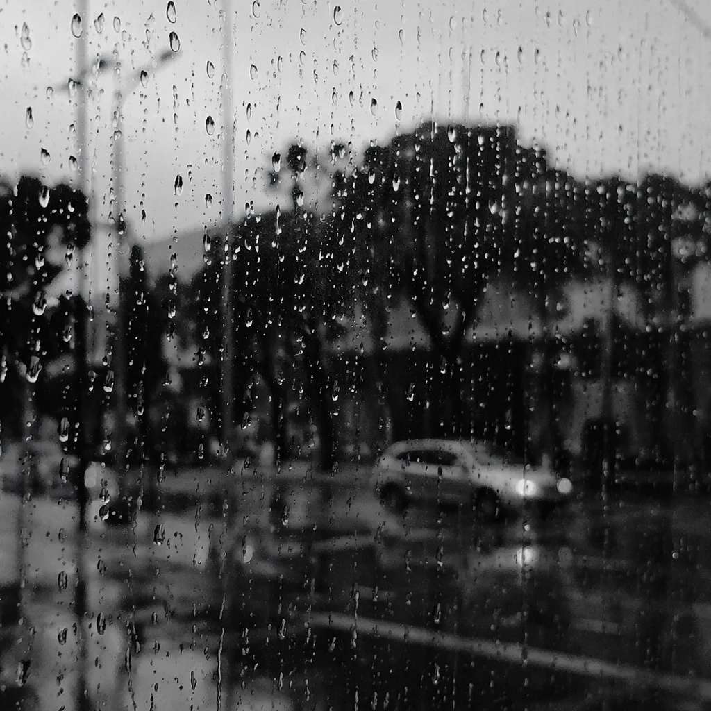 Rainy Window with Blurred City Street