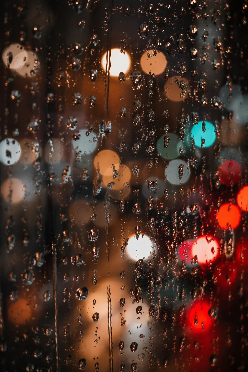 Rain Droplets on Night City Window