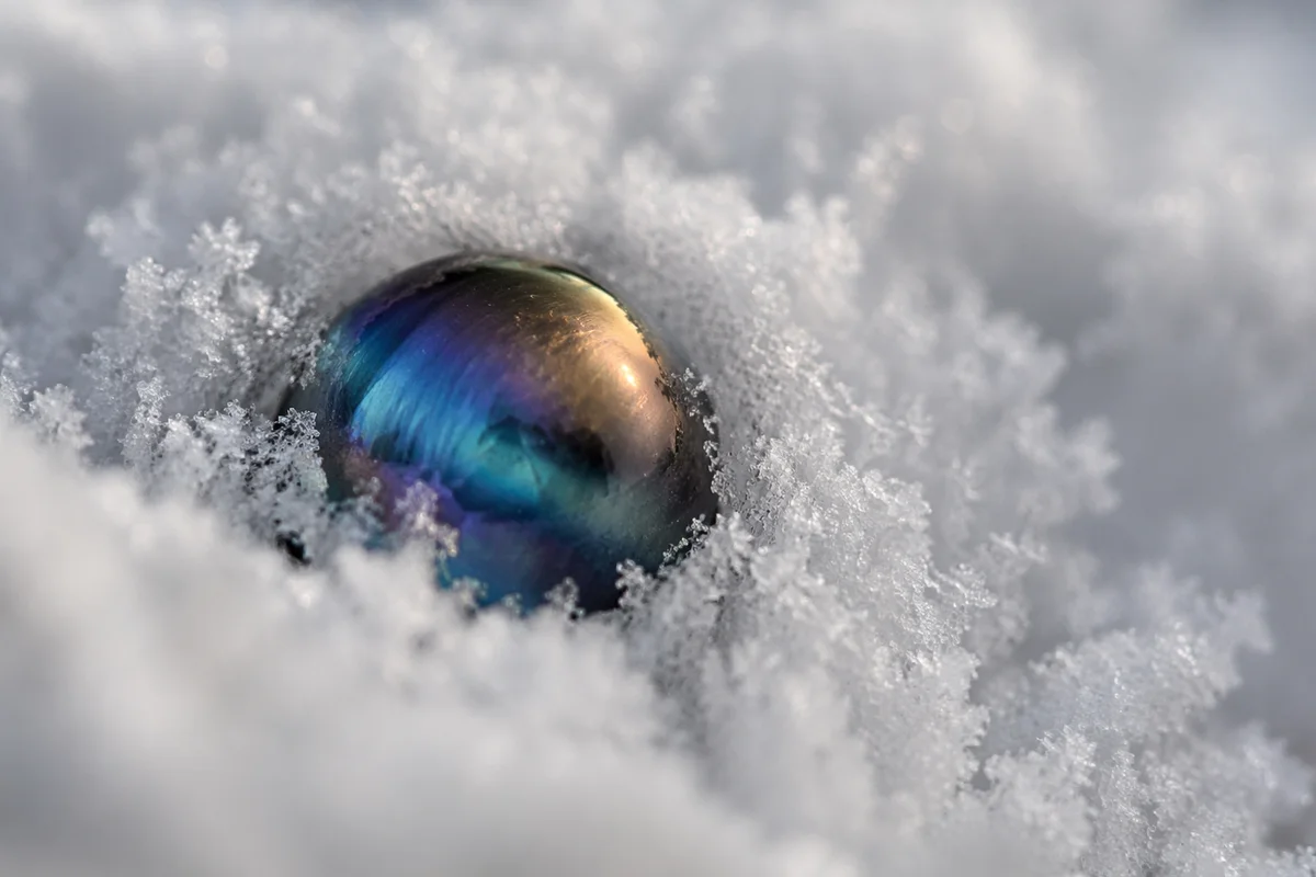 Iridescent Glass Sphere in Snow Crystals