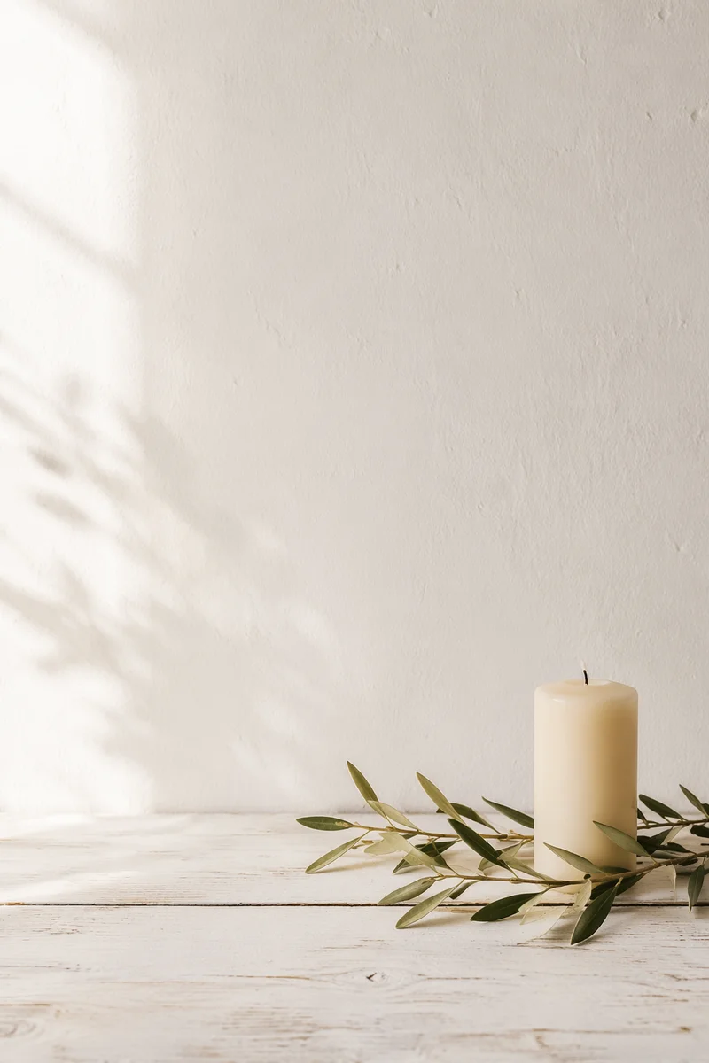 Minimal White Tabletop with Candle and Olive Branch