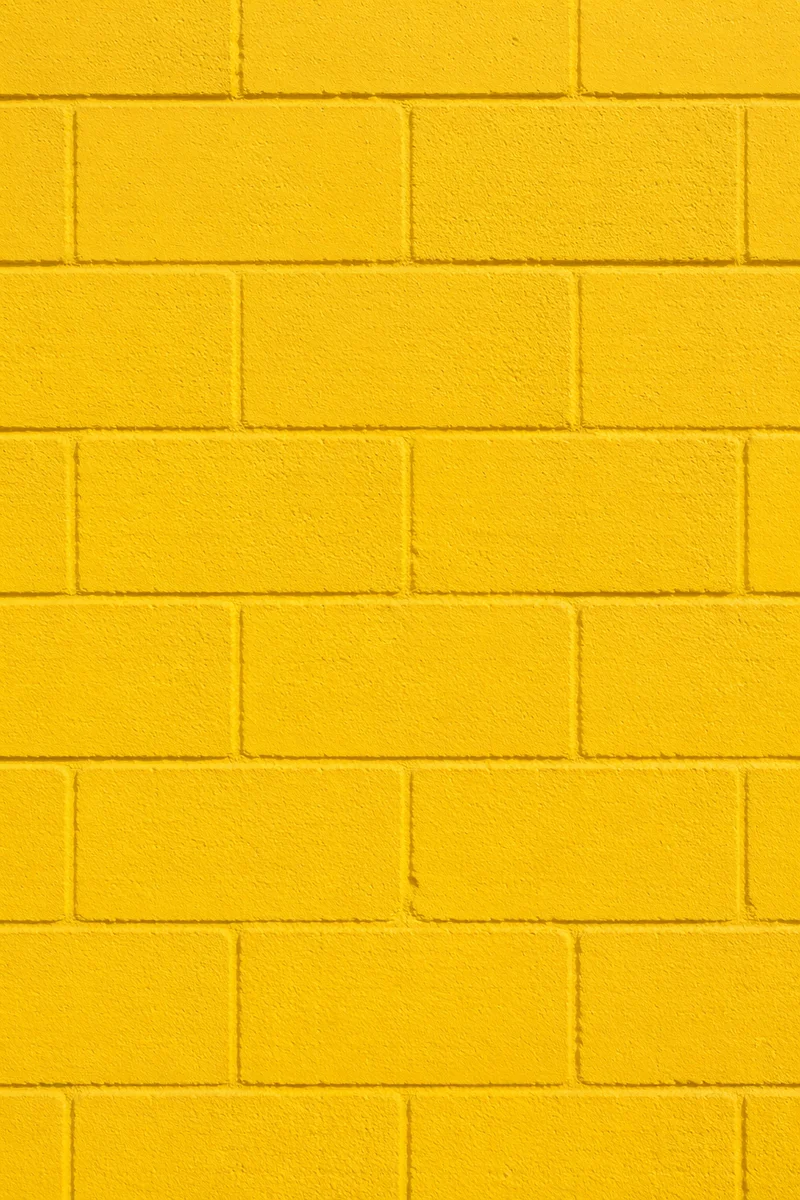 Bright Yellow Painted Concrete Wall Background
