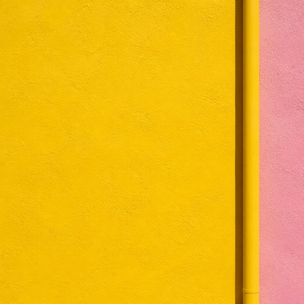 Bright Yellow Stucco Wall with Pink Accent