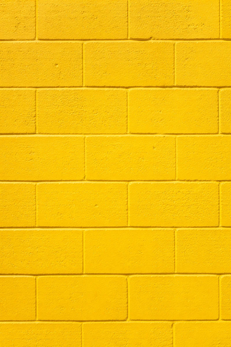 Bright Yellow Painted Concrete Wall Background