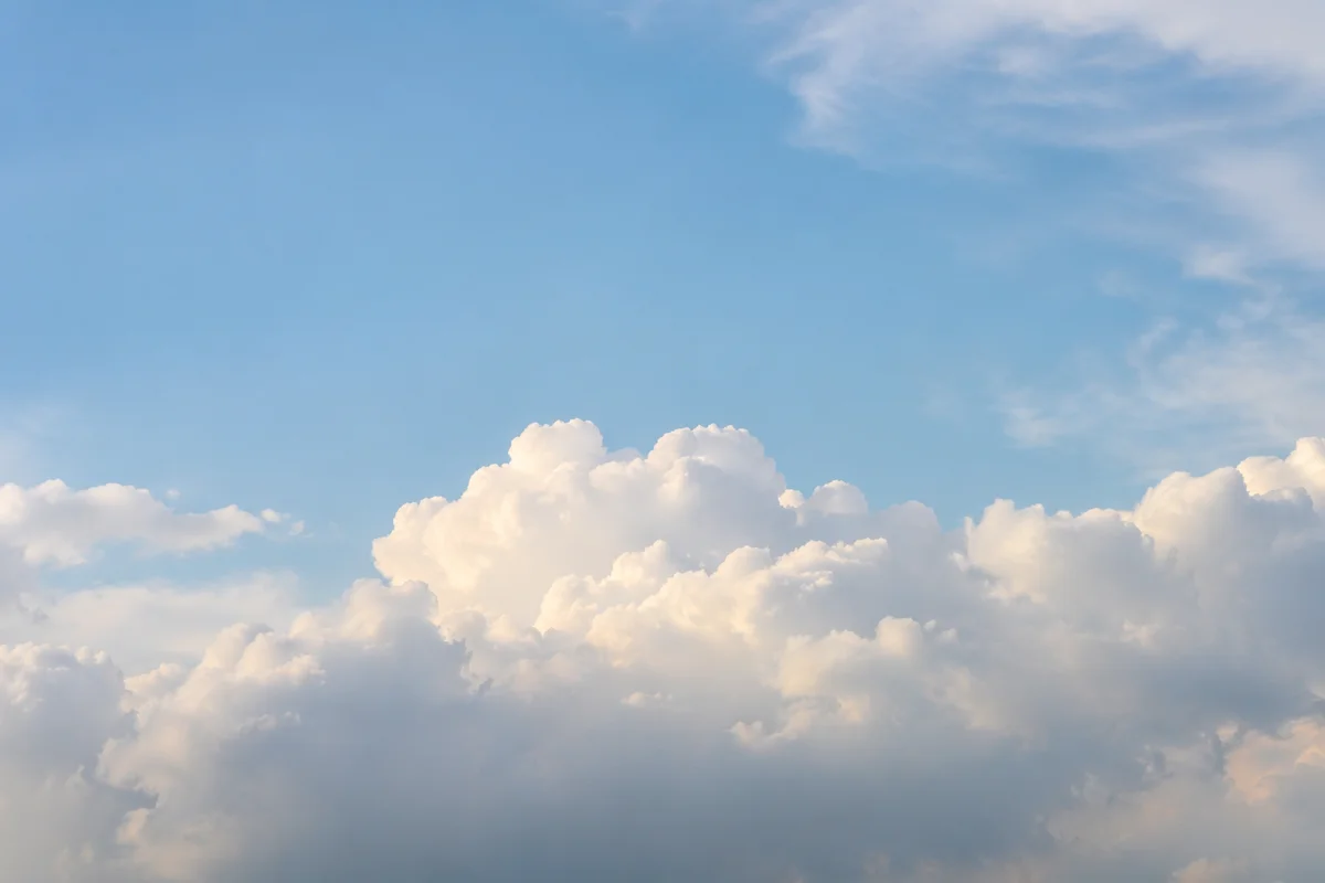 Serene Blue Sky With Soft Clouds