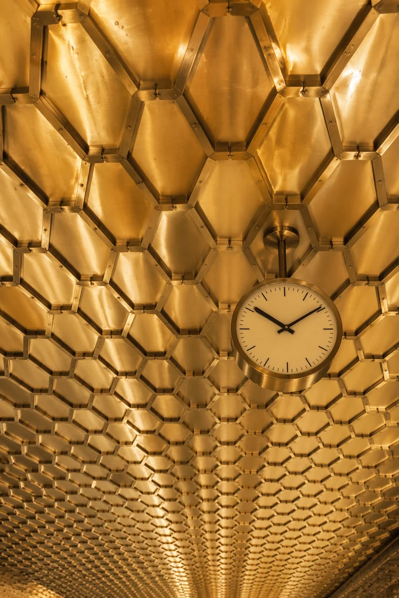 Golden Hexagonal Honeycomb Ceiling With Clock