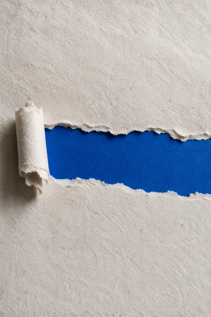 Torn White Paper Revealing Cobalt Blue