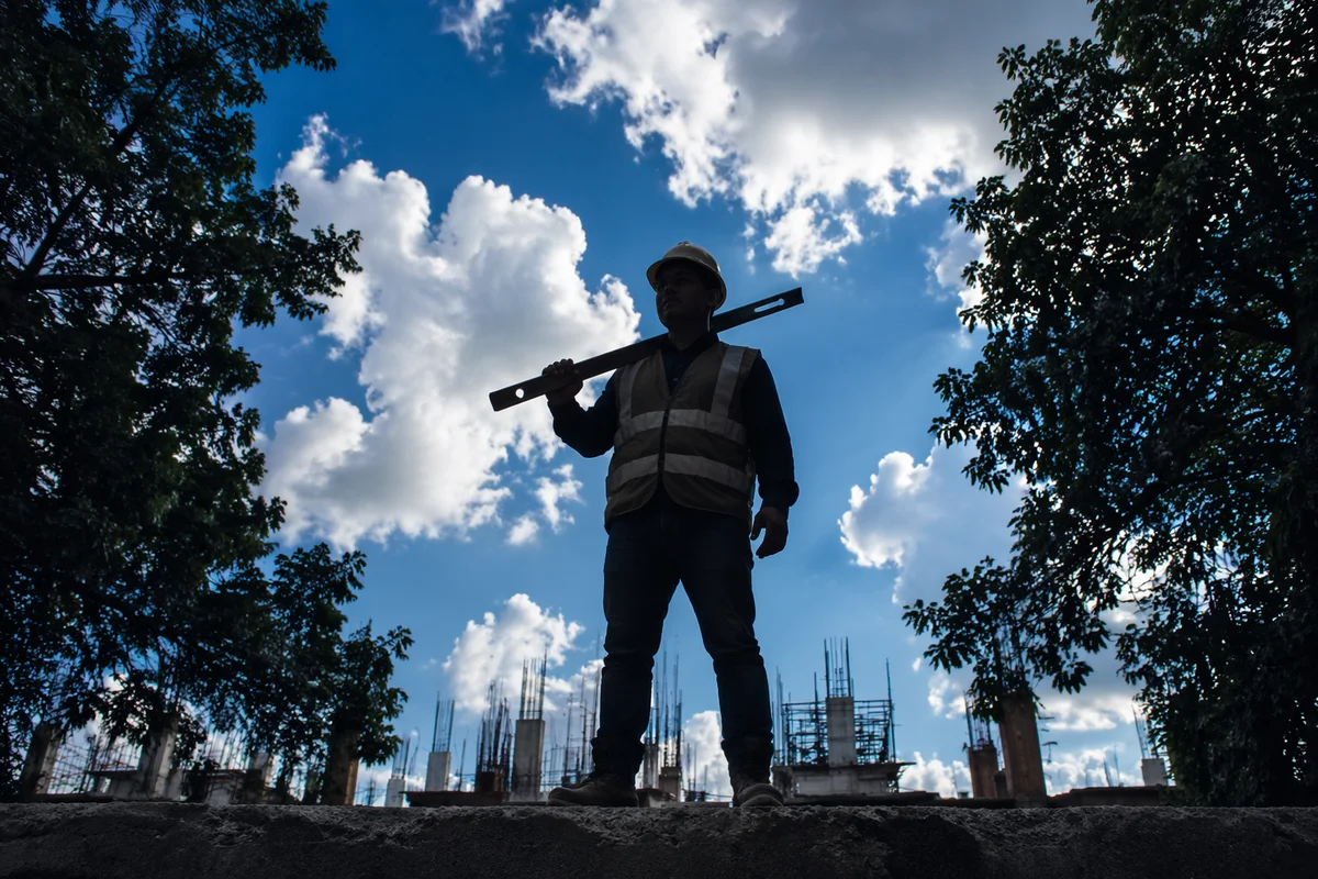 Confident Construction Worker Under Bright Sky