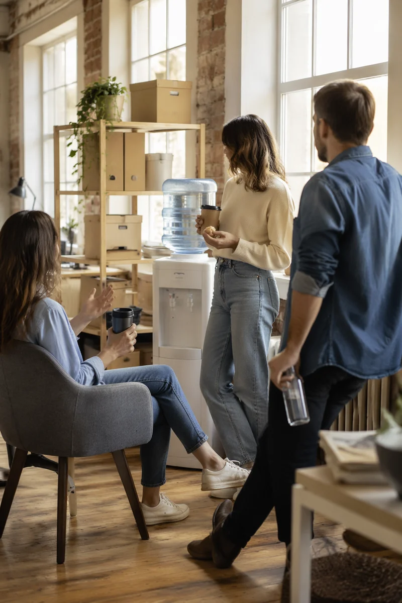 Coworkers Chatting at Office Water Cooler