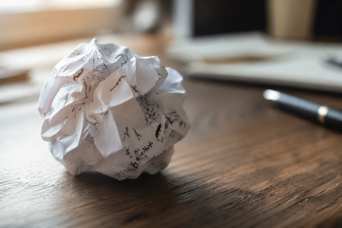 Crumpled Paper Ball on Office Desk