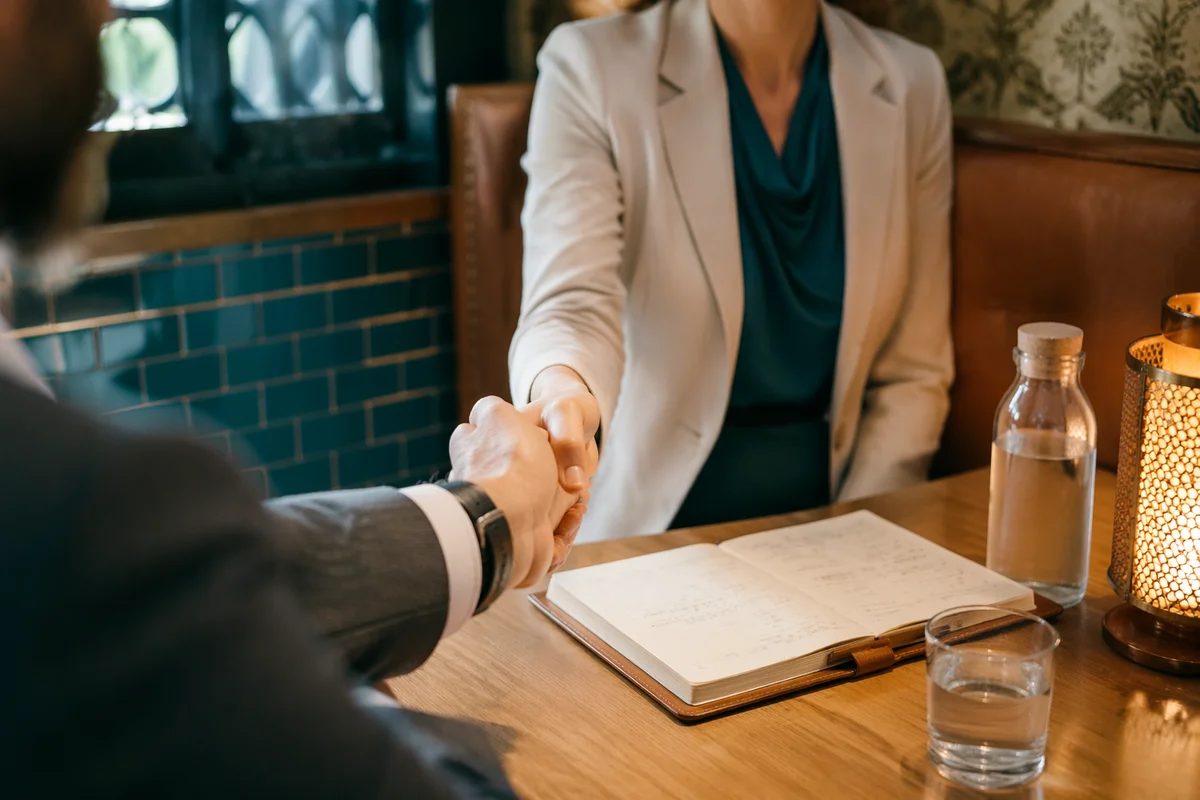 Professional Handshake Agreement in Cozy Café