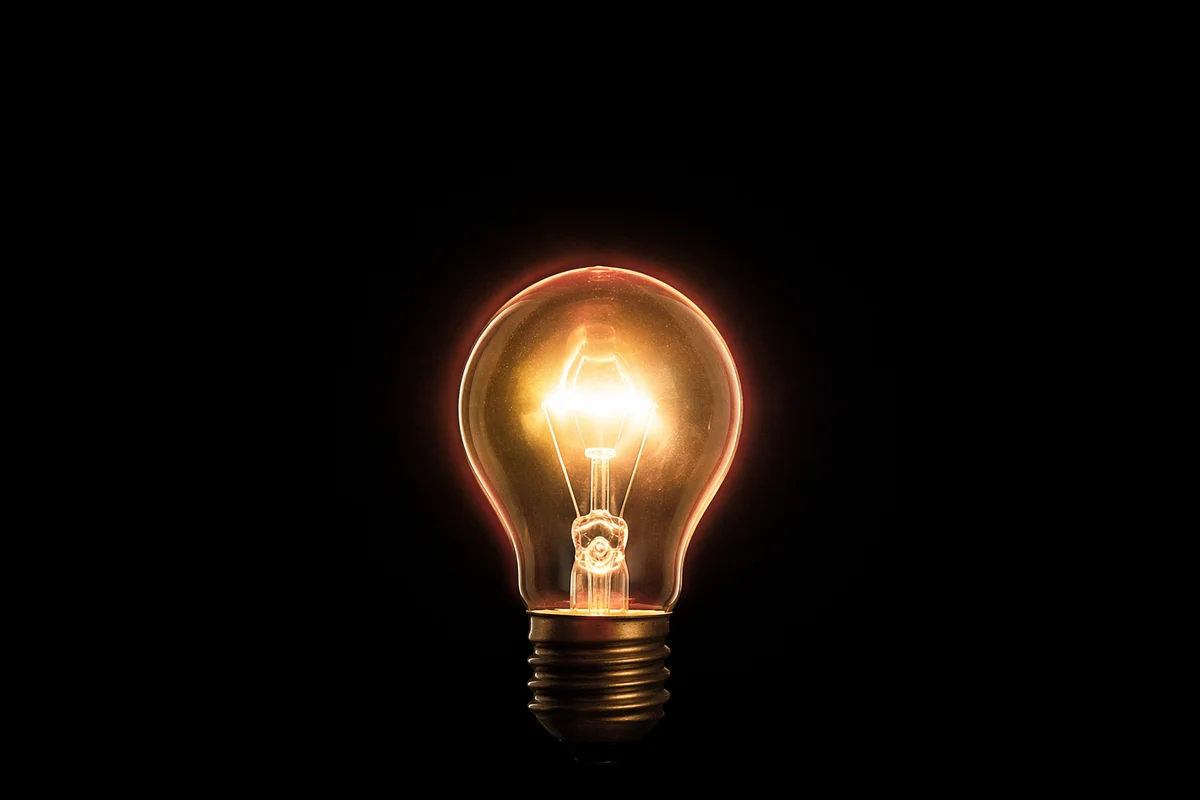 Glowing Lightbulb Business Idea on Black