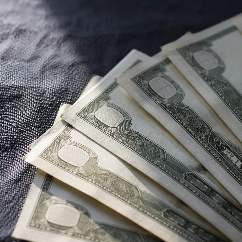 Close-Up Dollar Bills on Dark Fabric