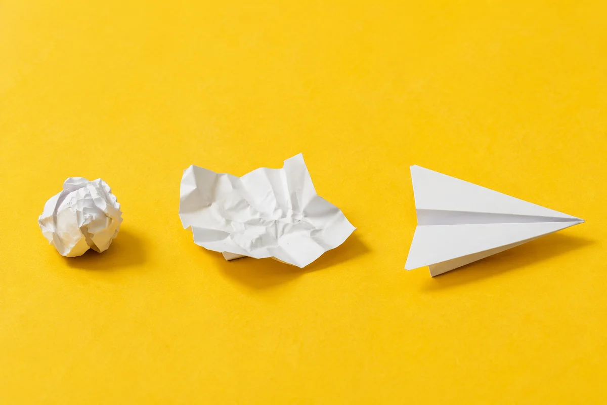 Paper Airplane Creativity on Yellow Desk