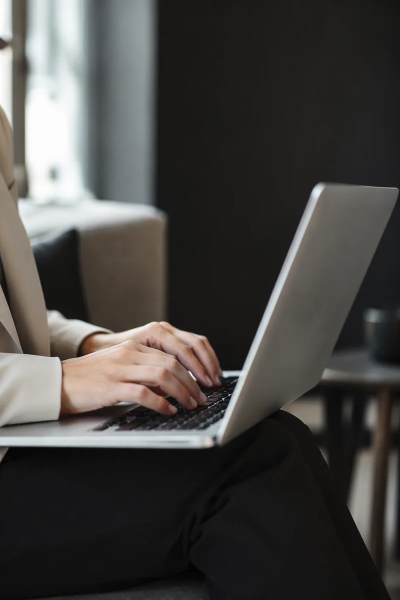 Professional Composing Email on Laptop