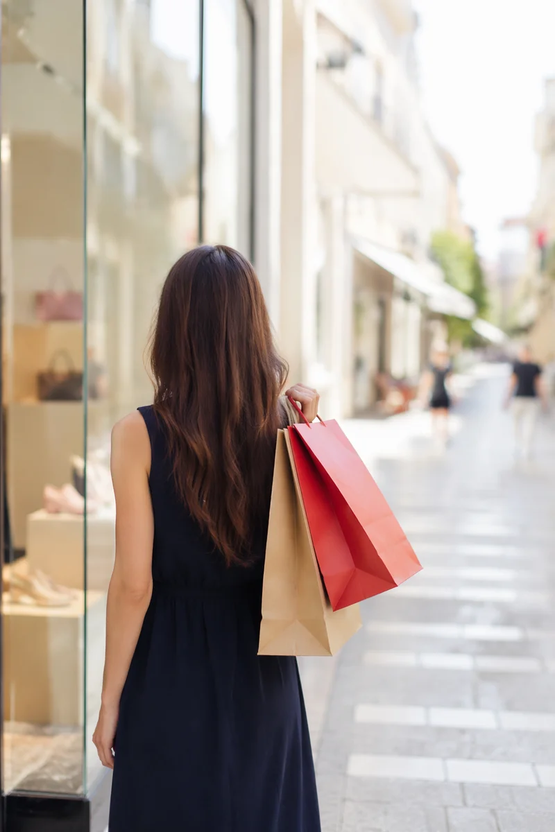 Elegant Shopper with Bags in Retail District