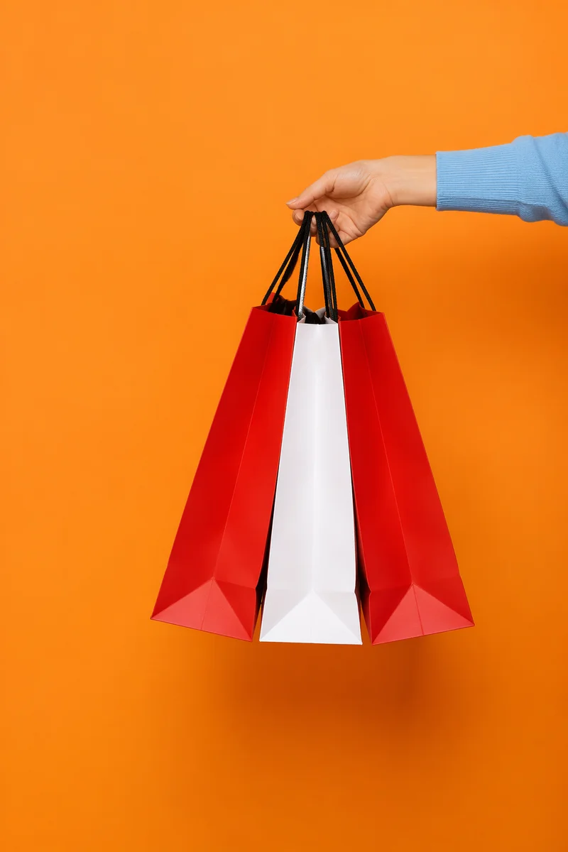 Hand Holding Colorful Retail Shopping Bags