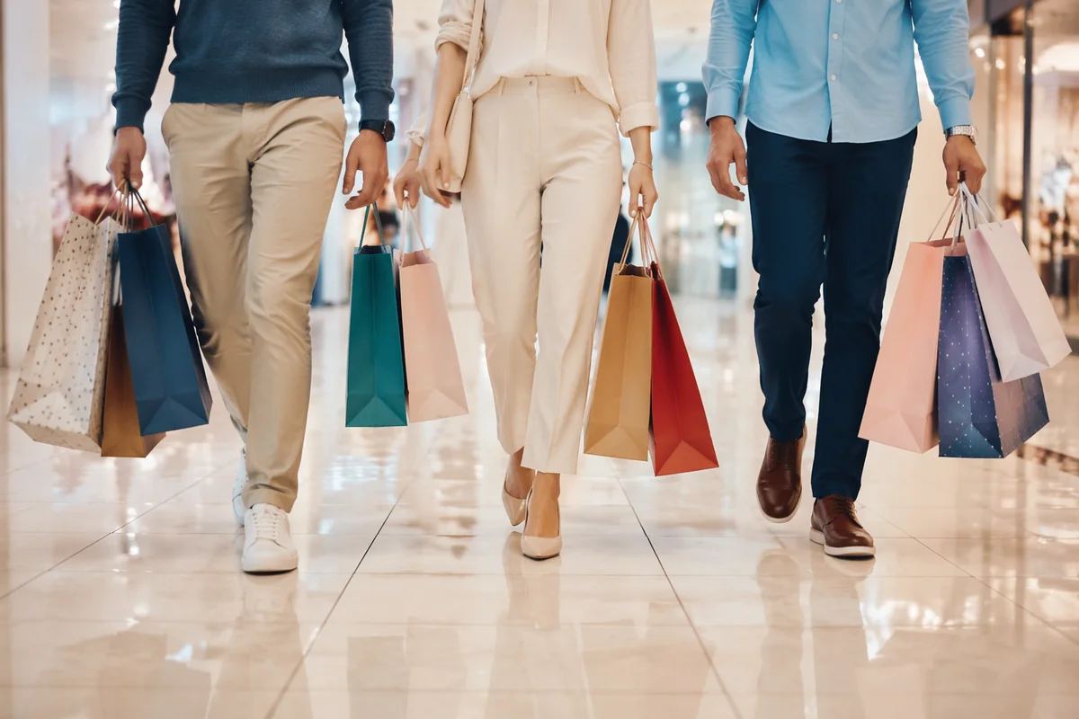 Modern Shoppers Carrying Bags in Retail Mall