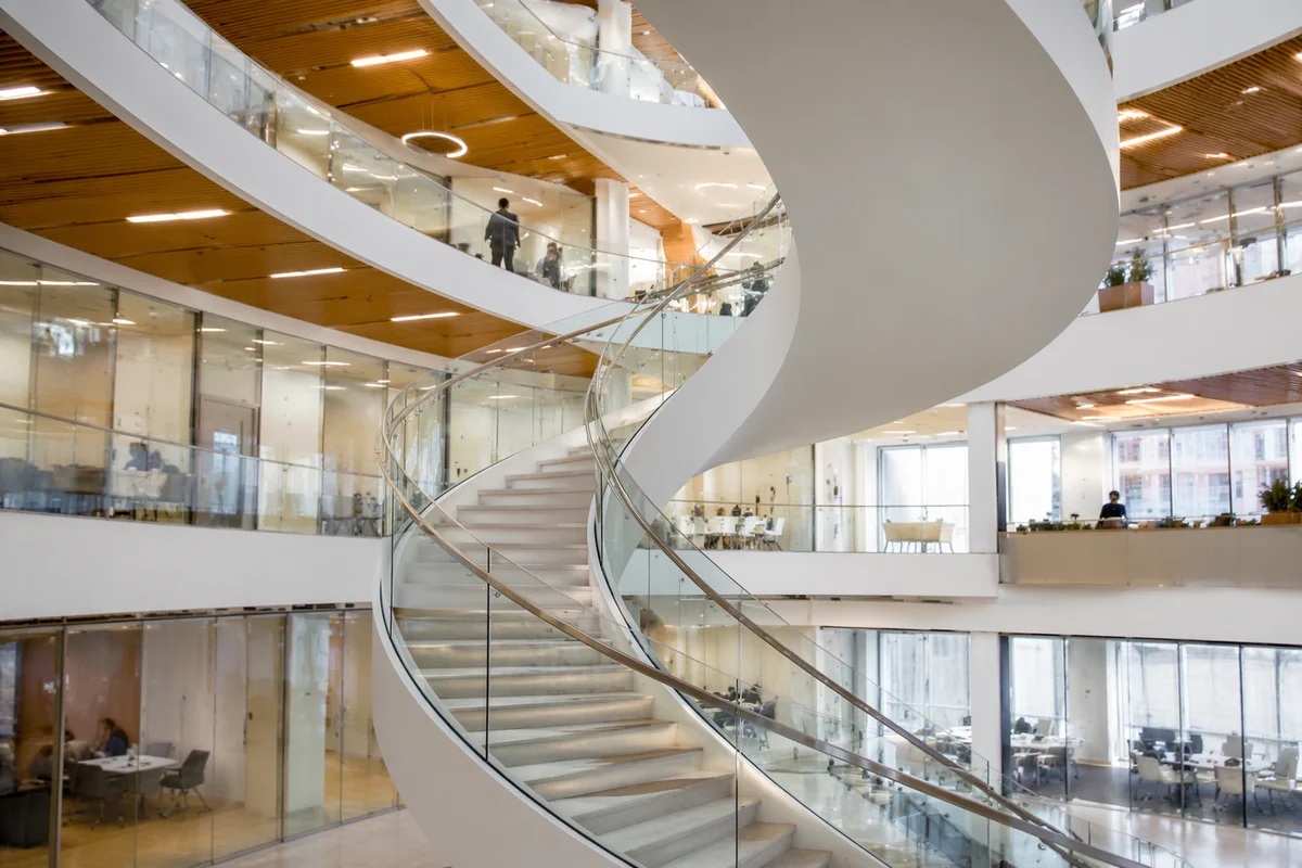 Ascending Spiral Staircase in Modern Office Atrium