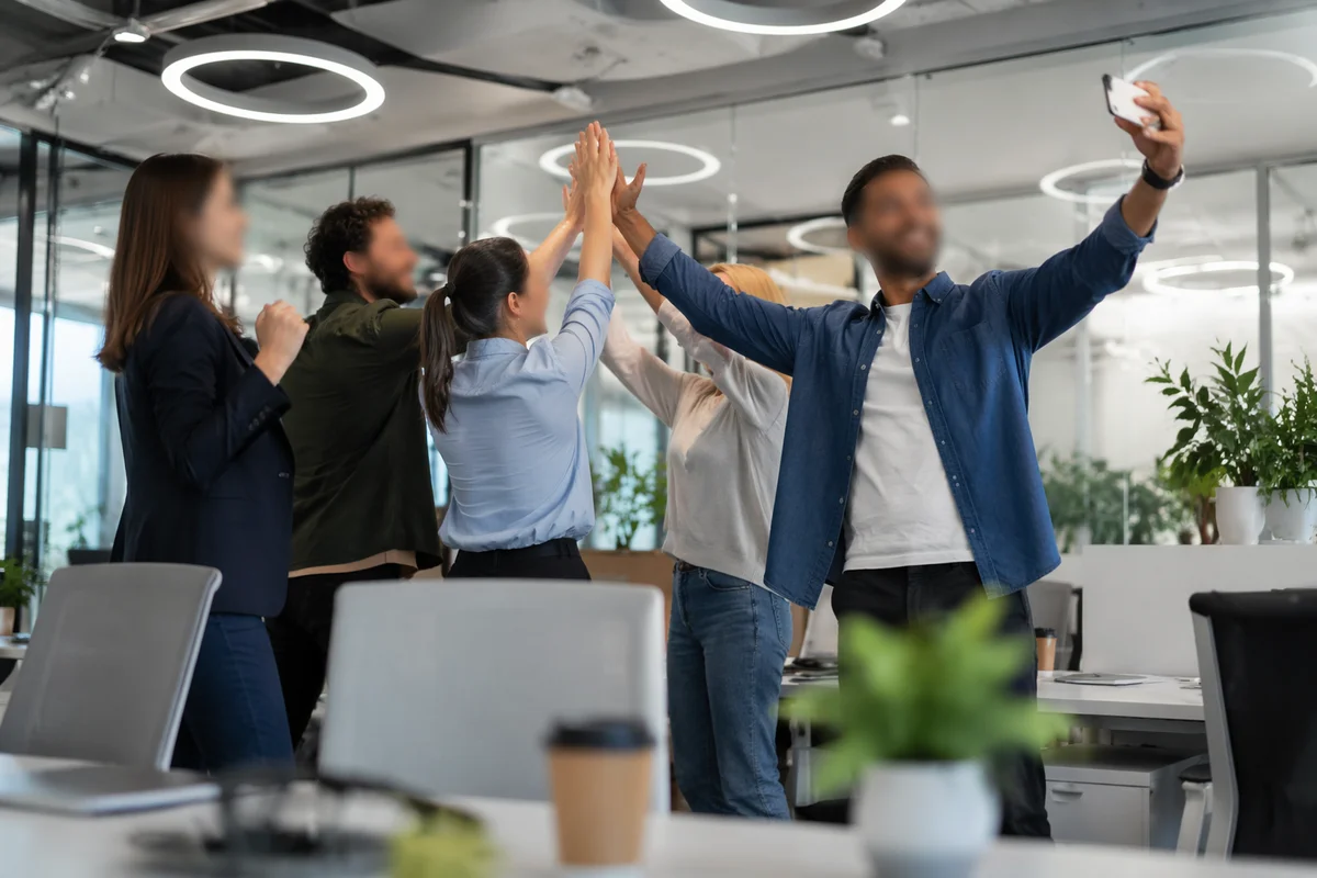 Coworkers Celebrating Project Success With High Fives