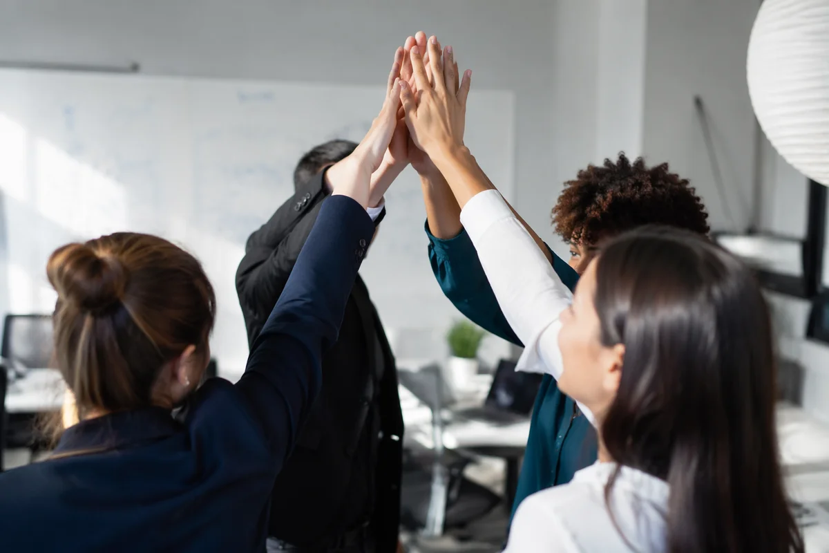 Office Team Celebrating Success with High Five